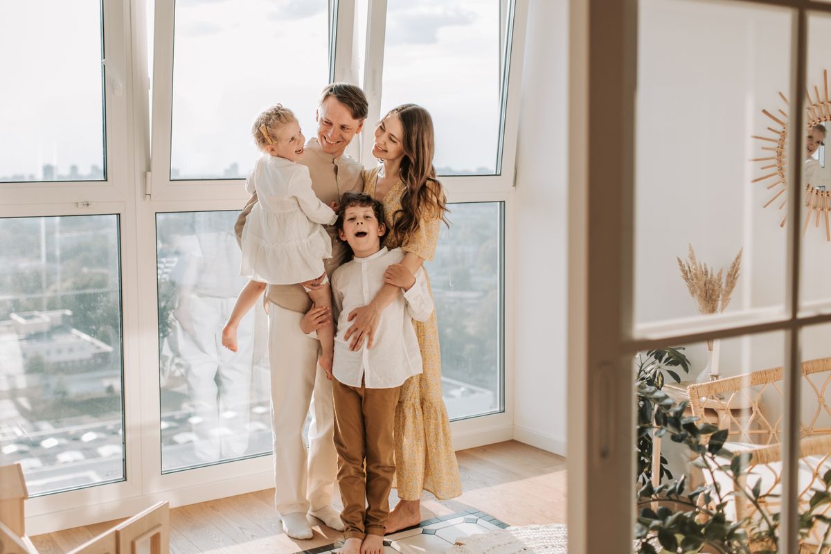 A warm family moment by a bright window at home